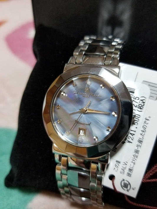 An elegant quartz wristwatch with a mother-of-pearl dial and stone indic #QY7IUQ