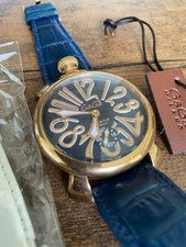 GaGa Milano hand-wound watch with blue leather strap, gold accents, and #QYFNSI
