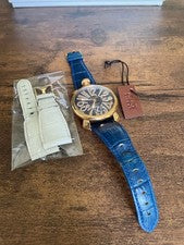 GaGa Milano hand-wound watch with blue leather strap, gold accents, and #QYFNSI