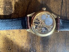 Hand-wound skeleton wristwatch, brown leather strap. #QY0GBX